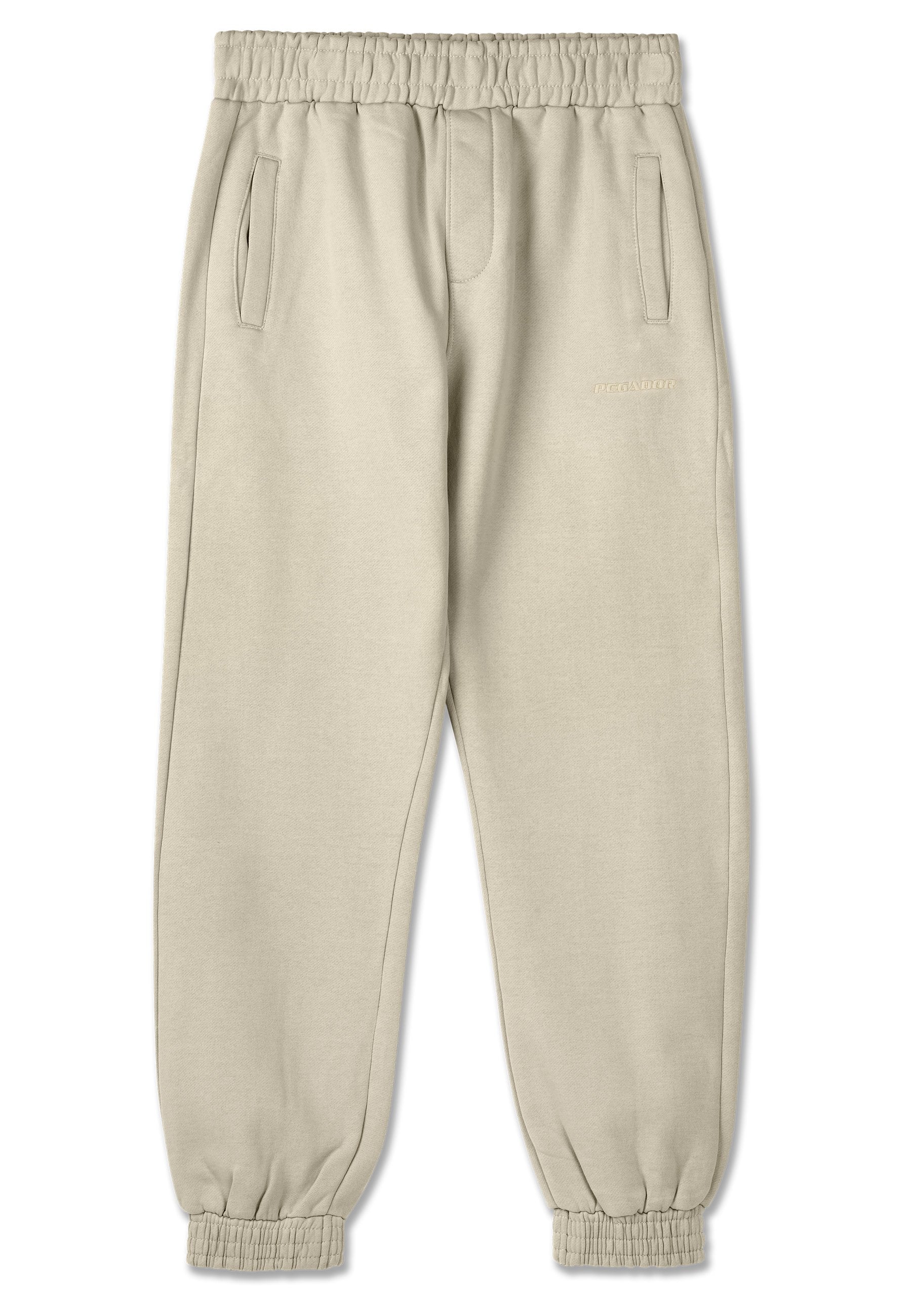 Beige Jogginghose aus weichem Stoff, mit einem Kordelzugbund, Seitentaschen, elastischen Bündchen und dezentem Branding in der Nähe des Bundes.