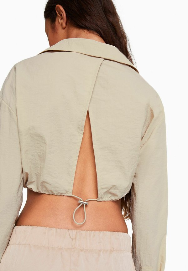 Bershka LONG SLEEVE AND GATHERED DETAIL AT THE FRONT WITH STOPPER