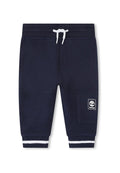 Marineblaue Jogginghosen aus strukturierter Baumwolle, mit einer weißen Kordel, Seitentasche und gestreiften Bündchen in Weiß. Timberland-Logo an der Seite.