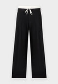 Schwarze Hosen mit weitem Bein, weißem elastischem Bund und Kordelzug, vorne mit Falten und glatter Textur.