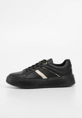 Schwarze Low-Top Sneaker mit dicker Sohle, Schnürverschluss und kontrastierendem beigem diagonalen Streifen an der Seite.