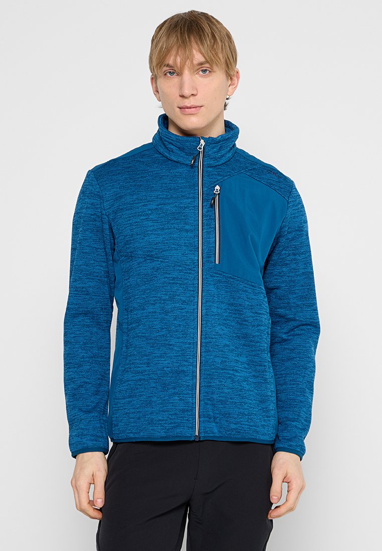 Blaue Jacke aus strukturiertem Stoff, durchgehender Reißverschluss, hoher Kragen, mit einer kontrastfarbenen Tasche mit Reißverschluss. Glattes Innenfutter und athletische Passform.