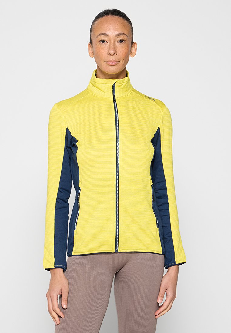 Gelbe Jacke mit Reißverschluss vorne, strukturiertem Stoff und kontrastierenden marineblauen Seitenpanelen. Verfügt über einen hohen Kragen und eine körpernahe Passform.