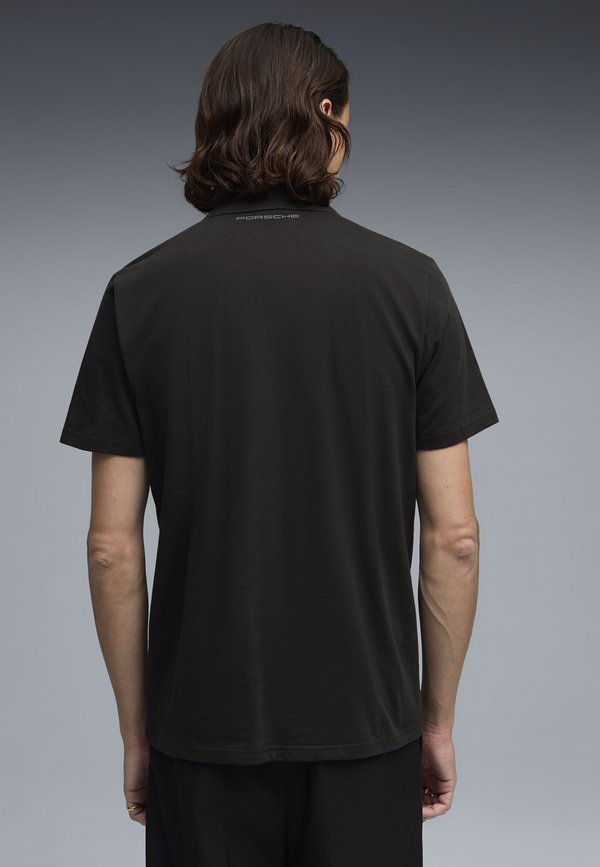 Puma PORSCHE LEGACY ESSENTIALS POLO - Polo shirt - black