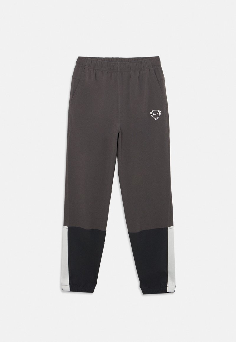 Dunkelgraue und schwarze Sporthose mit elastischem Bund, seitlichen Taschen, weiße Streifendetails an den unteren Beinen und Nike-Logo am linken Oberschenkel.