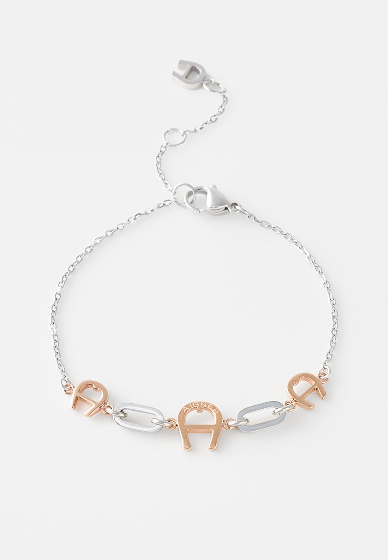 Silberne Kettenarmband mit roségoldenen hufeisenförmigen Gliedern und Karabinerverschluss, flach auf einem weißen Hintergrund ausgelegt.