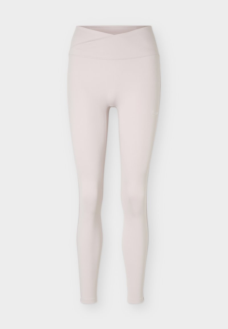 Hellbeige nahtlose Leggings mit hoher Taille und einem Detail eines gekreuzten Taillenbunds, flach auf weißem Hintergrund gezeigt.