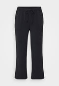 Schwarze Jogginghosen aus weichem Material, mit elastischem Bund und Kordelzug, seitlichen Taschen und geradem Bein. 