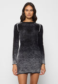 Strickkleid in einem Farbverlauf von Schwarz nach Grau, mit geripptem Muster, langen Ärmeln und einer figurbetonten Silhouette, ergänzt durch seitliche Einsätze.