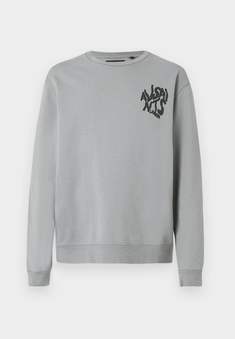 Hellgrauer Sweatshirt aus weichem Stoff, mit Rundhalsausschnitt und langen Ärmeln. Schwarzer Grafikslogan im linken Brustbereich.