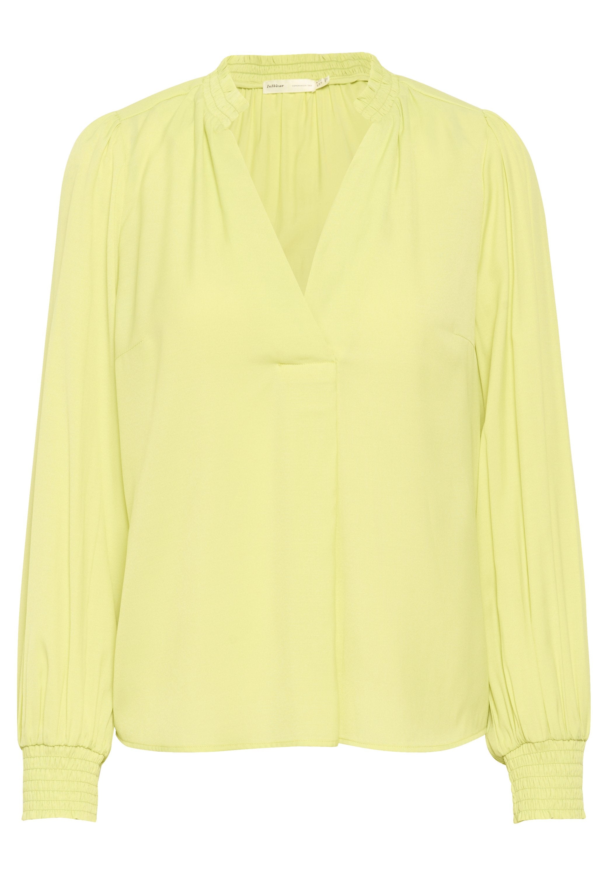 Limonengrüne Bluse mit V-Ausschnitt, langen Puffärmeln und gerafften Details an den Manschetten. Glattes Material, minimalistisches Design, keine Muster.