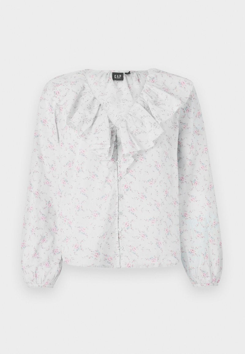 Weiße Bluse mit Rüschenausschnitt, floralen Mustern in Pink und Blau, langen Ärmeln und Knopfverschluss vorne. Leichter, strukturierten Stoff.
