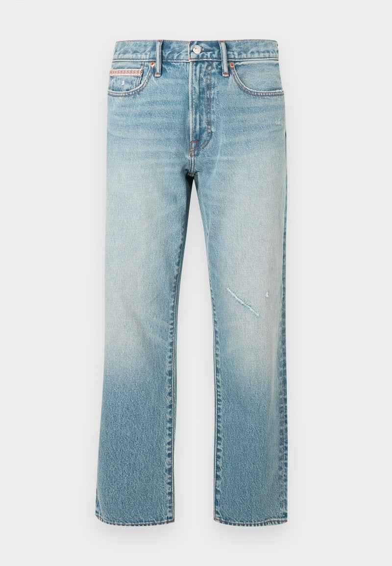 Hellblaue Denim-Jeans mit geradem Bein, einem ausgewaschenen Effekt und einer kleinen, abgenutzten Stelle. Sie verfügen über ein traditionelles Fünf-Taschen-Design und eine mittelhohe Taille.