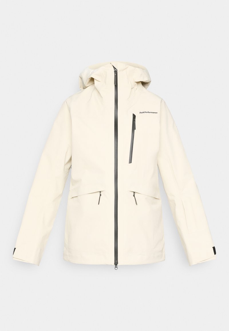 Cremefarbene Kapuzenjacke mit schwarzen wasserdichten Reißverschlüssen und Brusttasche, für Outdoor-Leistung konzipiert.