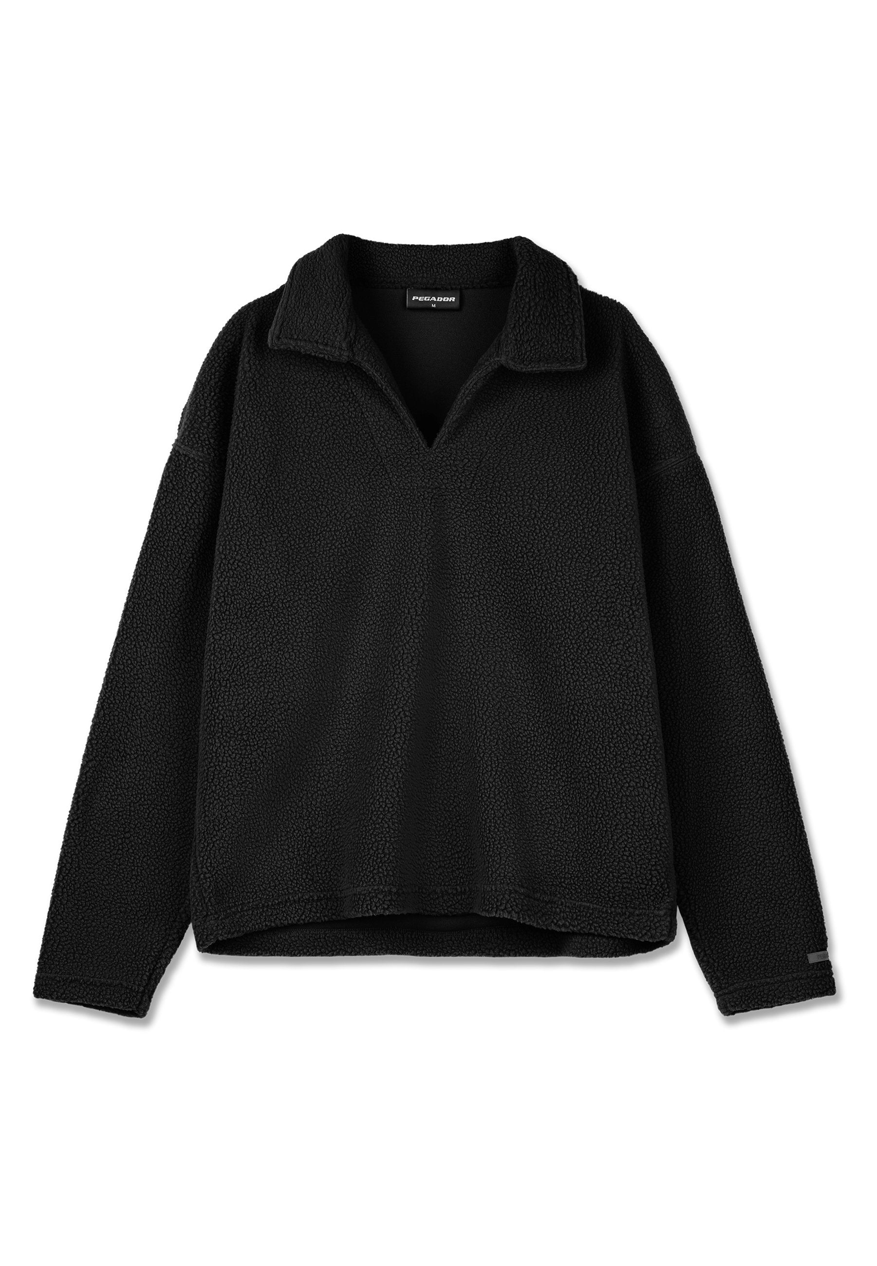 Schwarzer Pullover mit einer strukturierten, flauschigen Oberfläche, ausgestattet mit einem V-Ausschnitt und einem Kragen. Lange Ärmel und eine lockere Passform mit einem leicht verkürzten Saum.