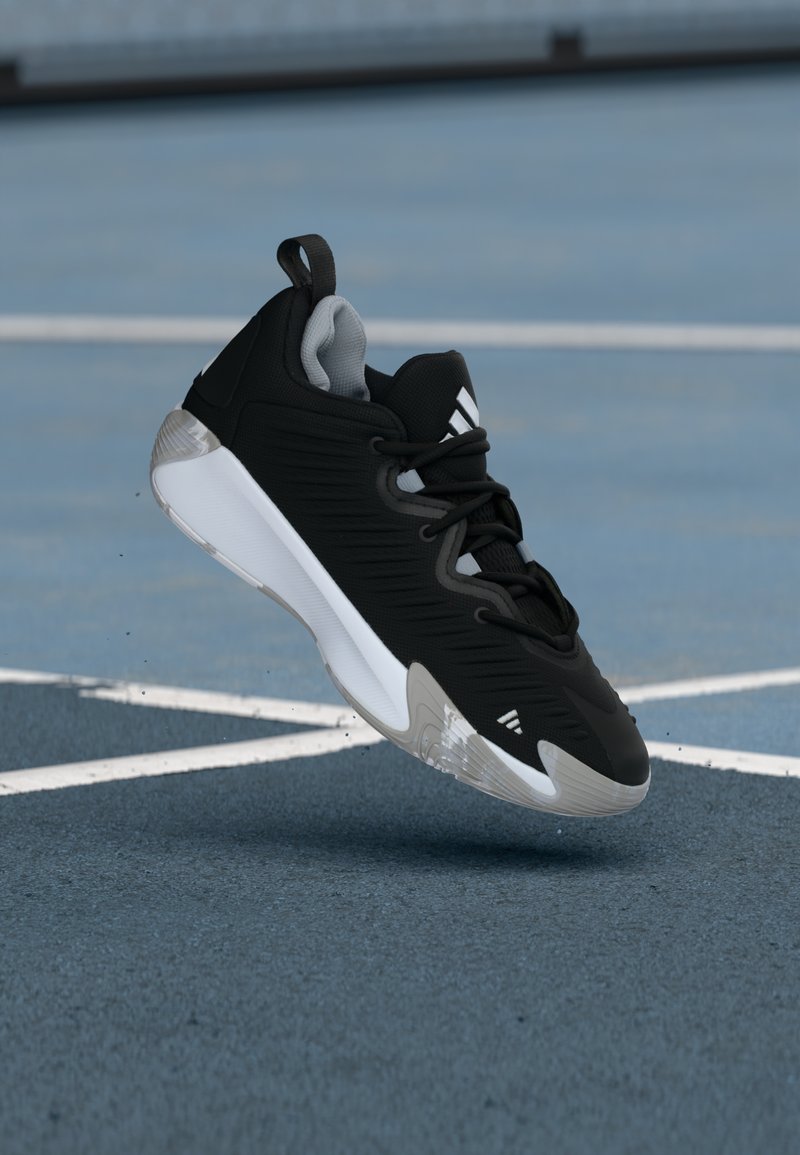 Schwarzer Sportschuh mit strukturiertem Obermaterial, grauen Akzenten, weißer Zwischensohle und transparenter Außensohle. Vorderfuß mit verstärktem Design.