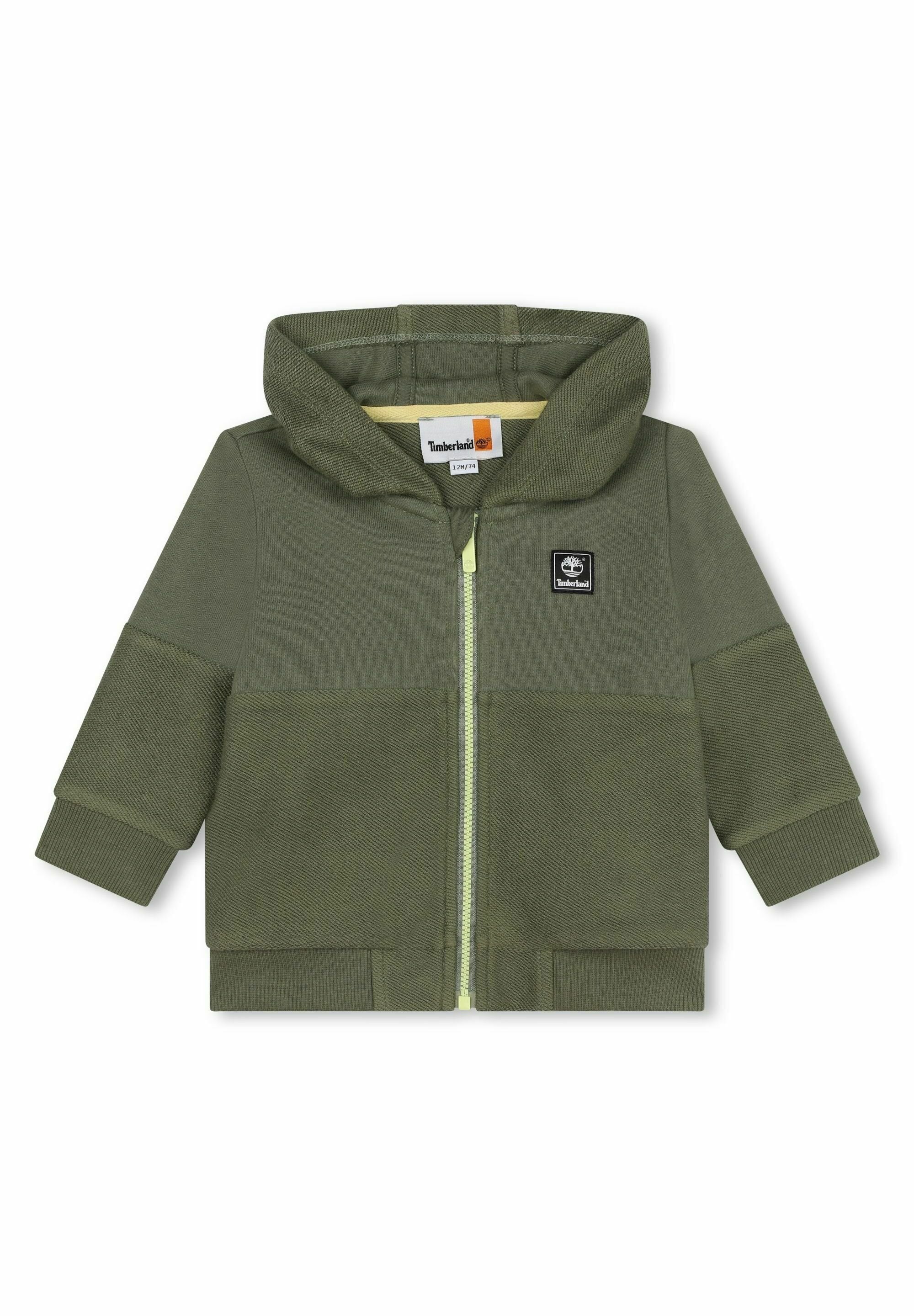 Olivgrüner Hoodie mit einem Reißverschluss vorne, strukturiertem Stoff und einem gelben Akzent-Reißverschluss. Verfügt über eine gerundete Kapuze und gerippte Bündchen.