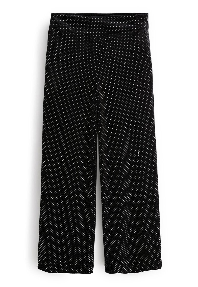 Schwarze weit geschnittene Hose mit weißen Punkten, mit einem dehnbaren Bund für zusätzlichen Komfort. Weicher Stoff und lockere Passform.