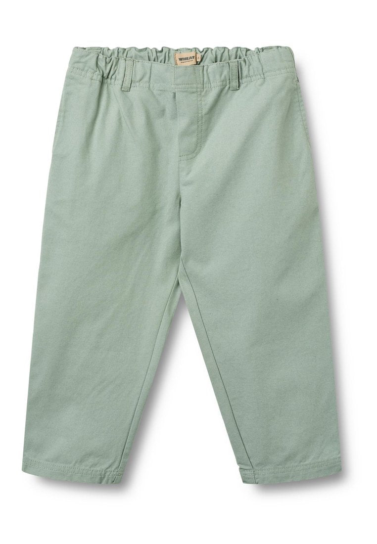Hellgrüne Baumwollhose mit elastischem Bund, schmal zulaufendem Bein und durchgehend normalen Nähten.