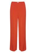 Weite Hosen aus leuchtend orangefarbenem Polyester mit glatter Textur und einem elastischen Bund. Keine sichtbaren Taschen oder Muster.