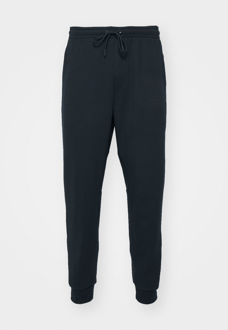 Schwarze Jogginghose mit einem Kordelzugbund, gepufften Knöcheln und einem glatten Baumwollmischgewebe. Verfügt über eine einzelne Vordertasche.