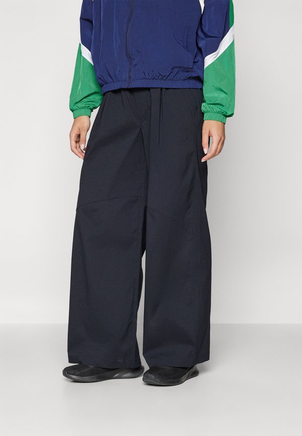 Under Armour UNSTOPPABLE WOVEN - Trousers - black