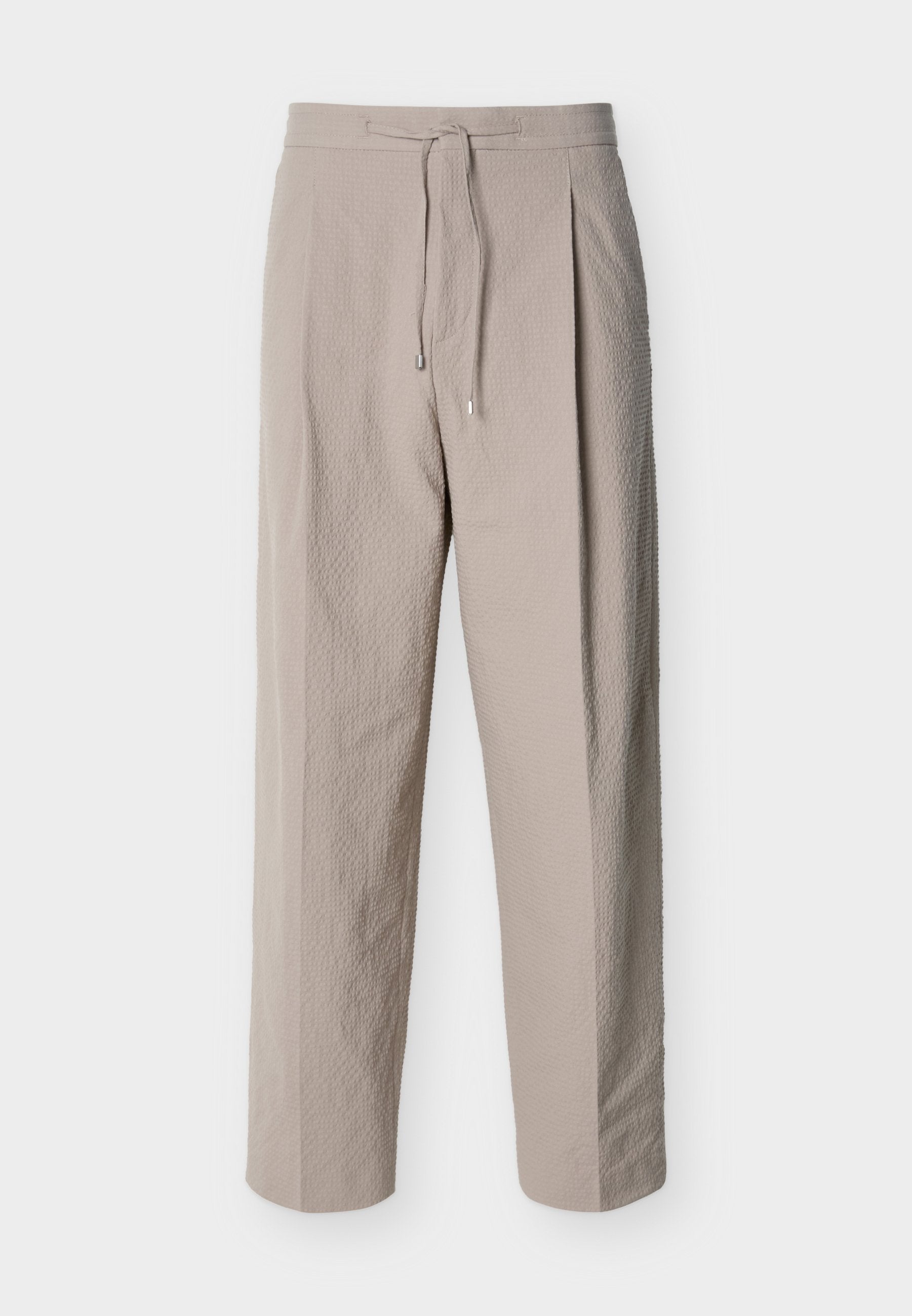 Beige strukturierte Hose mit Kordelzug, geraden Beinen und elastischem Bund, auf weißem Hintergrund dargestellt.