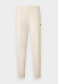 Cremefarbene Slim-Fit-Jogginghose mit elastischem Bund und Bündchen, mit einem kleinen schwarzen Logo am oberen Oberschenkel.
