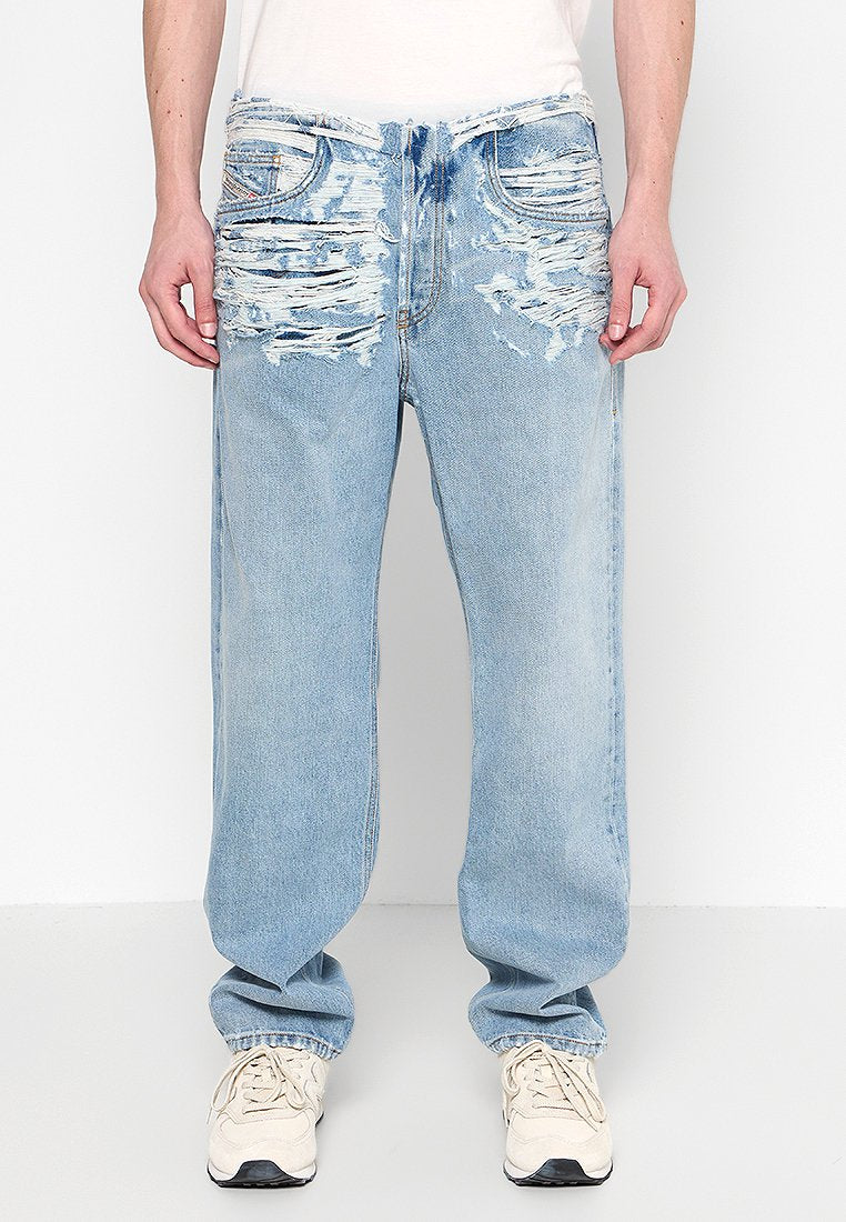 Hellblaue, ausgewaschene Jeans mit fransigen Details, lockerer Passform und klassischem Fünf-Taschen-Design, kombiniert mit weißen Sneakers.