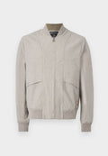 Hellbeige Bomberjacke mit Frontreißverschluss, geripptem Kragen, Bündchen, Saum und zwei aufgesetzten Taschen mit Druckknopf vorne.