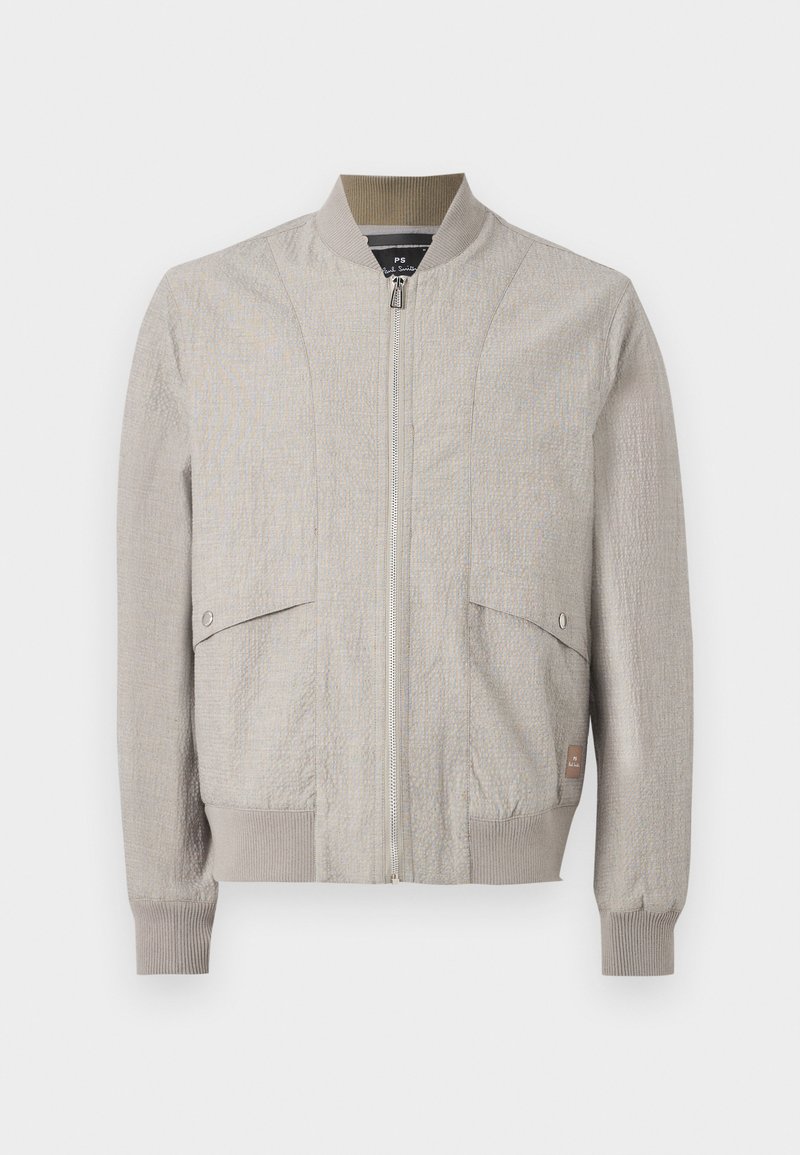 Hellbeige Bomberjacke mit Frontreißverschluss, geripptem Kragen, Bündchen, Saum und zwei aufgesetzten Taschen mit Druckknopf vorne.