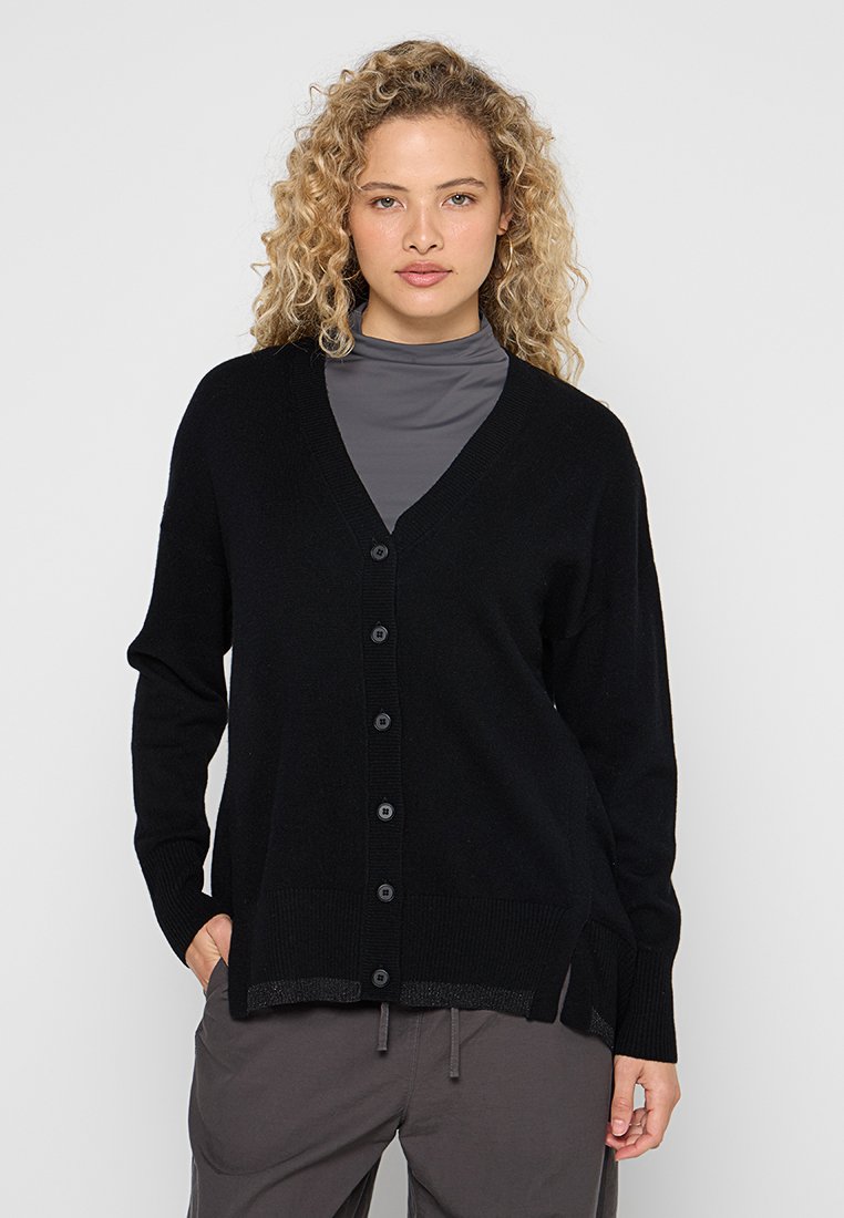 Schwarze Strickjacke aus weichem Material, mit V-Ausschnitt, langen Ärmeln und Knopfverschluss vorne. Texturierter Saum und seitliche Schlitze sorgen für Details.