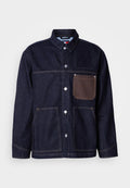 Dunkelblaue Jeansjacke mit Kragen, vorderer Knopfleiste und zwei großen Taschen. Mit braunem Taschenakzent und kontrastierenden Nähten.