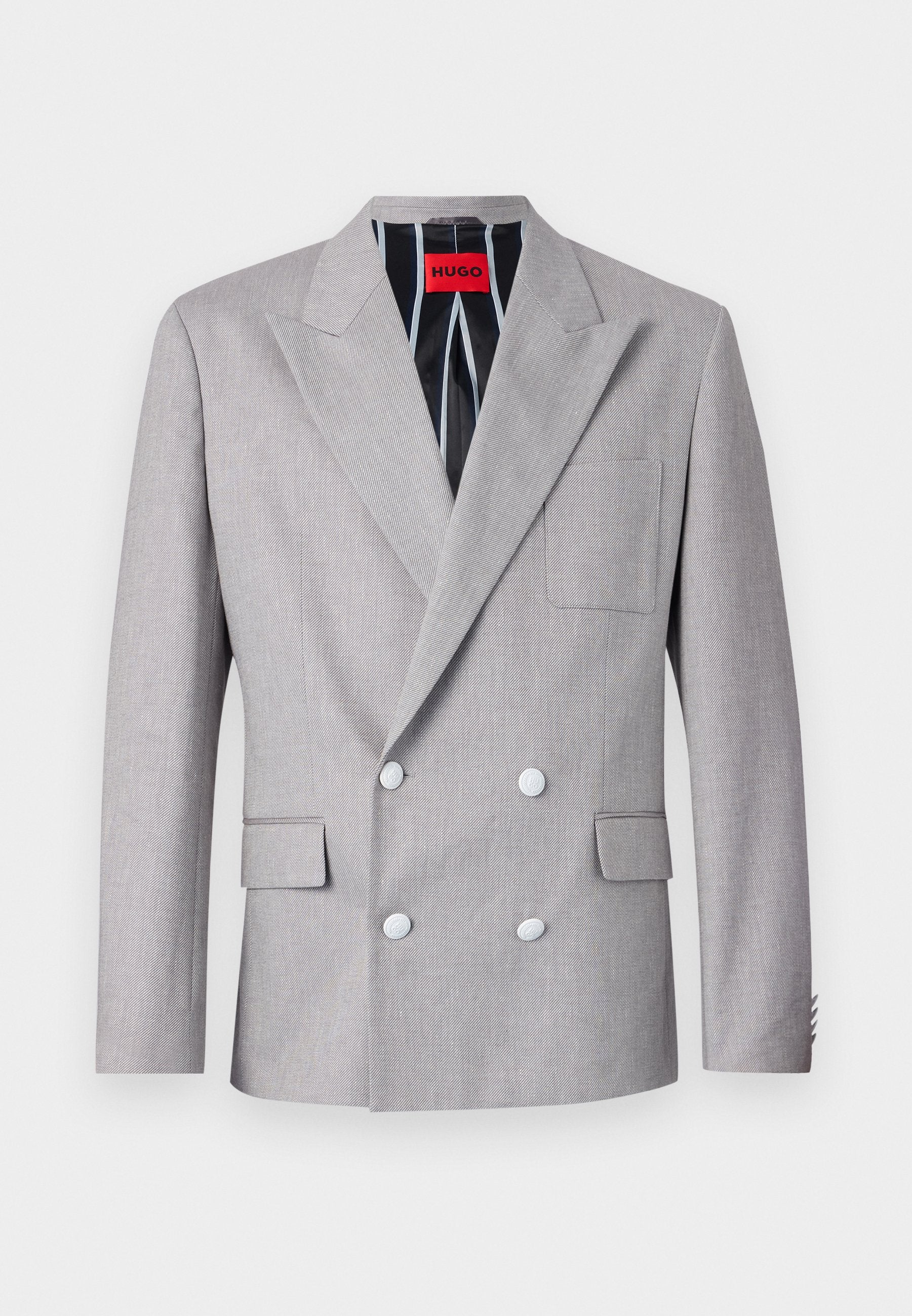 Grauer doppelt-knöpfiger Blazer aus strukturiertem Stoff. Mit spitzen Revers, zwei vorderen Taschen und weißen Knöpfen. Gefüttert mit gestreiftem Muster.