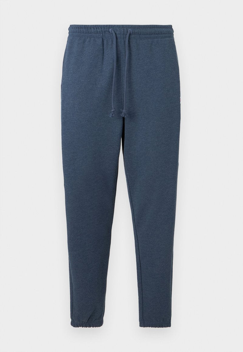 Marineblaue schmal geschnittene Jogginghosen mit elastischem Bund und Kordelzug, versehen mit elastischen Bündchen an den Knöcheln.