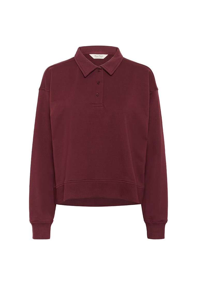 Langärmeliges, dunkelburgunderfarbenes Poloshirt mit drei Knöpfen, klassischem Kragen, gerippten Bündchen und einem leicht verkürzten Saum.
