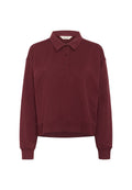 Langärmeliges, dunkelburgunderfarbenes Poloshirt mit drei Knöpfen, klassischem Kragen, gerippten Bündchen und einem leicht verkürzten Saum.