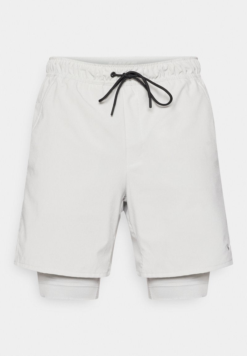 Hellgraue Sportshorts mit elastischem Bund, schwarzer Kordel und eingearbeitetem Innenfutter. Glatter Stoff mit Seitentaschen.