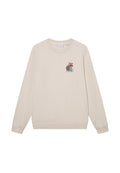 Hellbeige Sweatshirt aus weichem Material, mit einem kleinen bunten Motiv auf der Brust, langen Ärmeln und gerippten Bündchen.