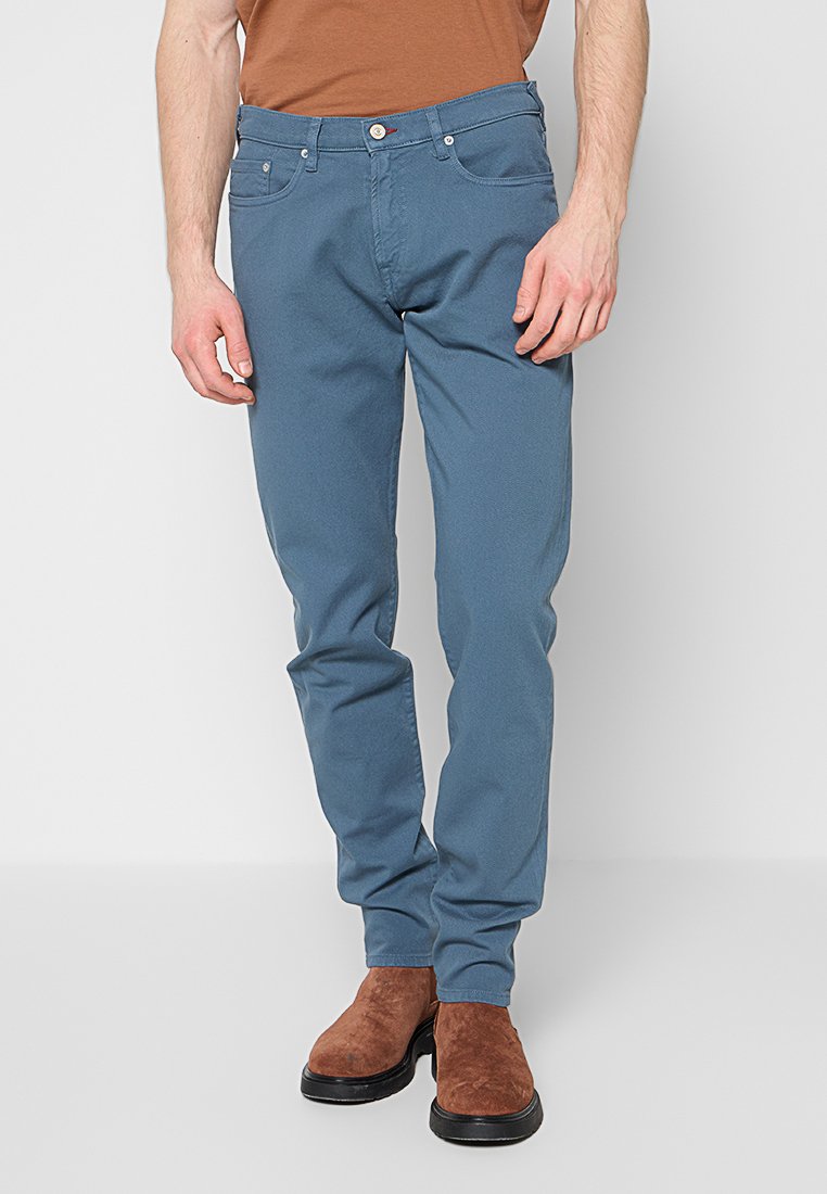 Blaue Baumwollhosen mit schlanker Passform, ausgestattet mit fünf Taschen, einem Knopf- und Reißverschluss sowie dezenten Nahtdetails.
