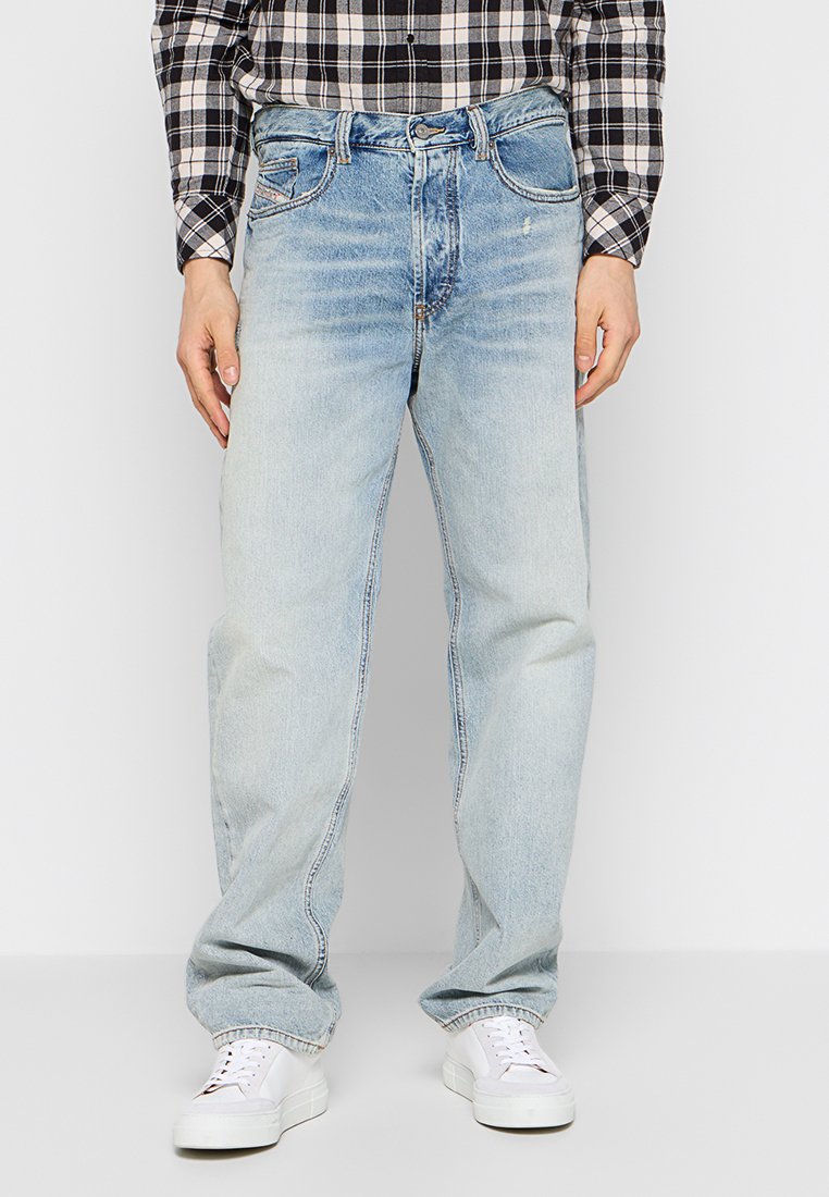 Helle blaue Denim-Jeans mit lockerem Schnitt, kontrastierenden Nähten, Fünf-Taschen-Design und leicht gelebtem Finish.