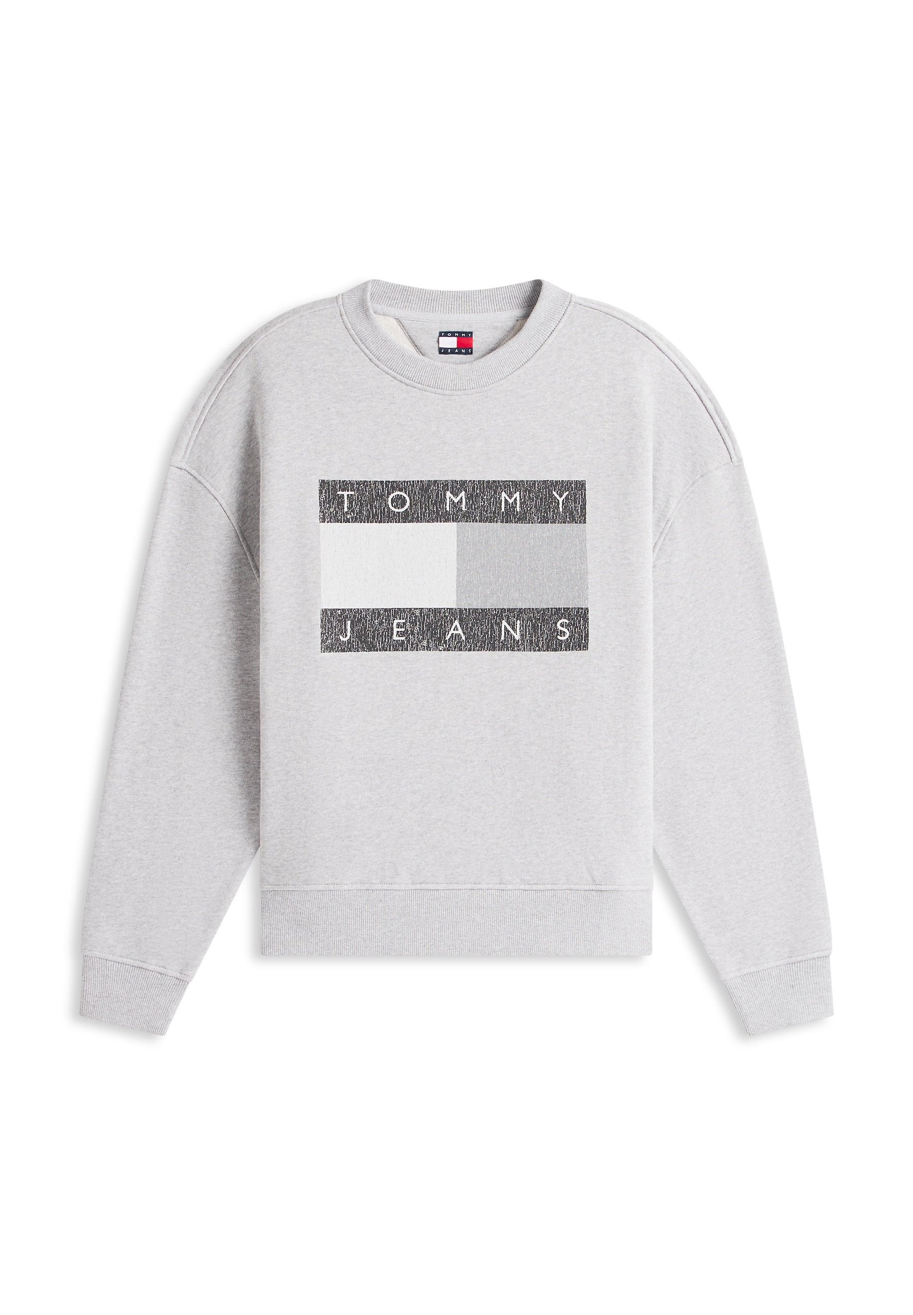 Grauer Sweatshirt mit langen Ärmeln und gerippten Bündchen. Mit einem rechteckigen schwarz-weißen Motiv mit dem Schriftzug "TOMMY JEANS" auf der Brust.