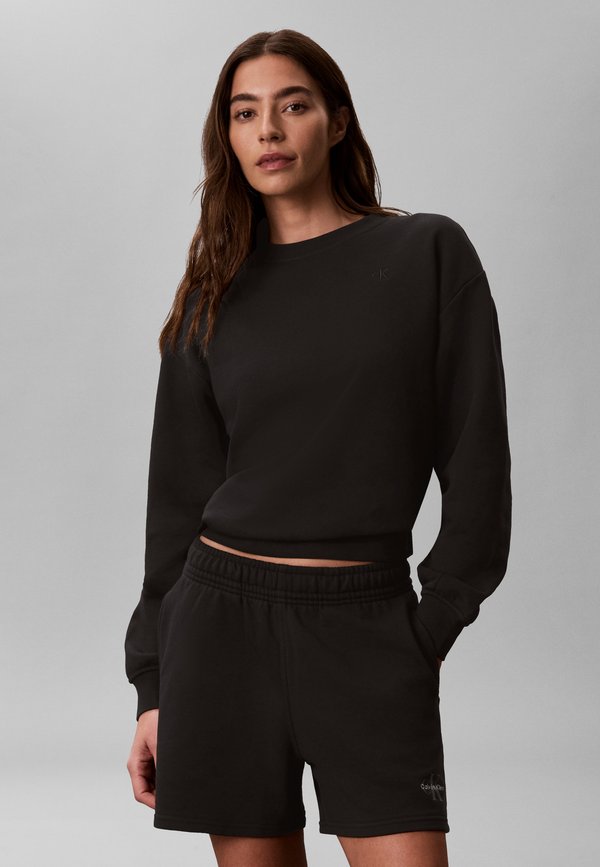 Calvin Klein Jeans MONOLOGO - Tracksuit bottoms - black