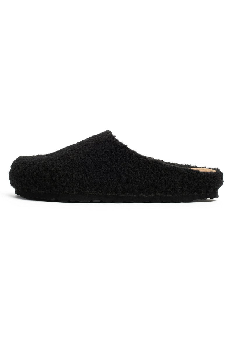 Schwarze Hausschuhe aus strukturiertem, flauschigem Material mit einem flachen Design. Gerundete Spitze und geschwungene obere Kante. Flexible Gummisohle.