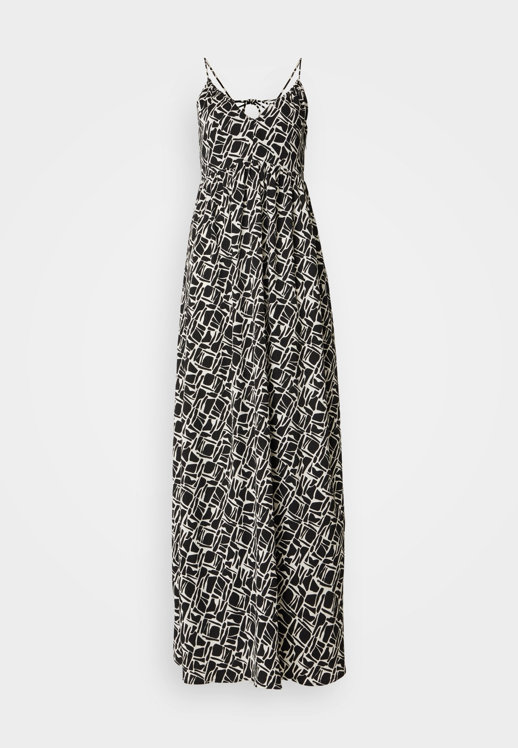 Maxikleid in Schwarz und Weiß mit geometrischem Muster, ausgestattet mit dünnen verstellbaren Trägern und einem lockeren Schnitt, aus leichtem Stoff gefertigt.