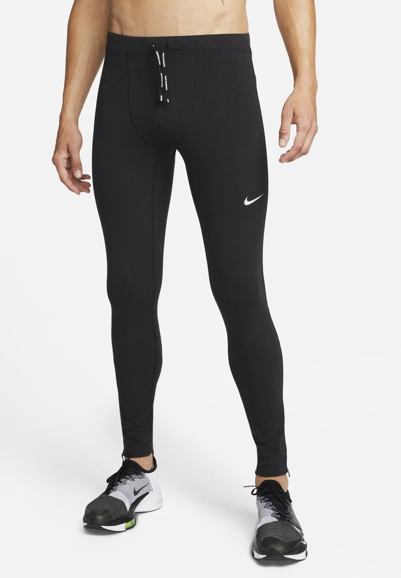 Schwarze Sportleggings mit enger Passform, aus dehnbarem Material gefertigt, mit einem weißen Nike-Logo und einem verstellbaren Zugband an der Taille.