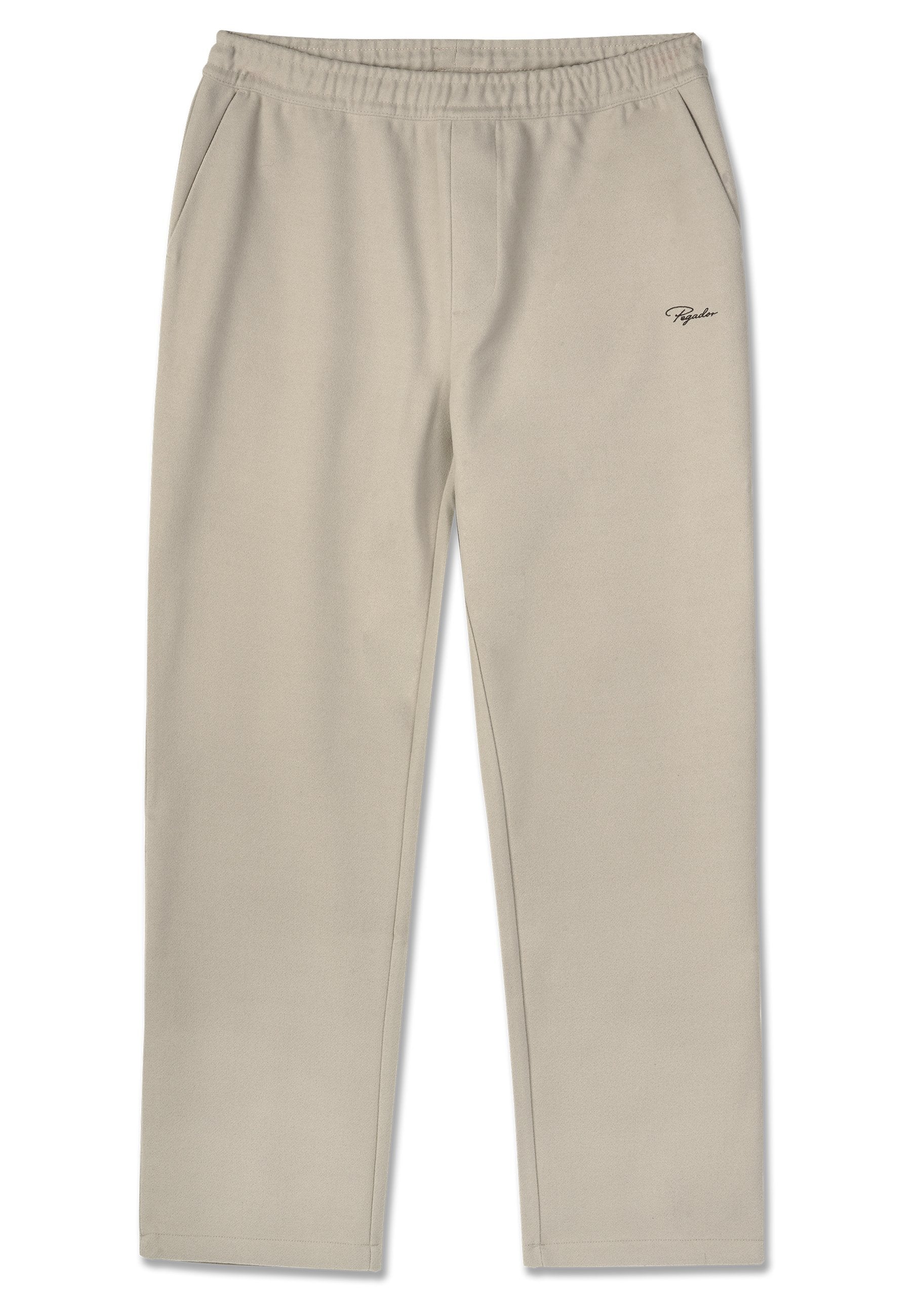 Beige Jogginghose aus weichem Stoff, mit einem elastischen Bund, zwei Seitentaschen und einem kleinen Logo auf der linken Seite.