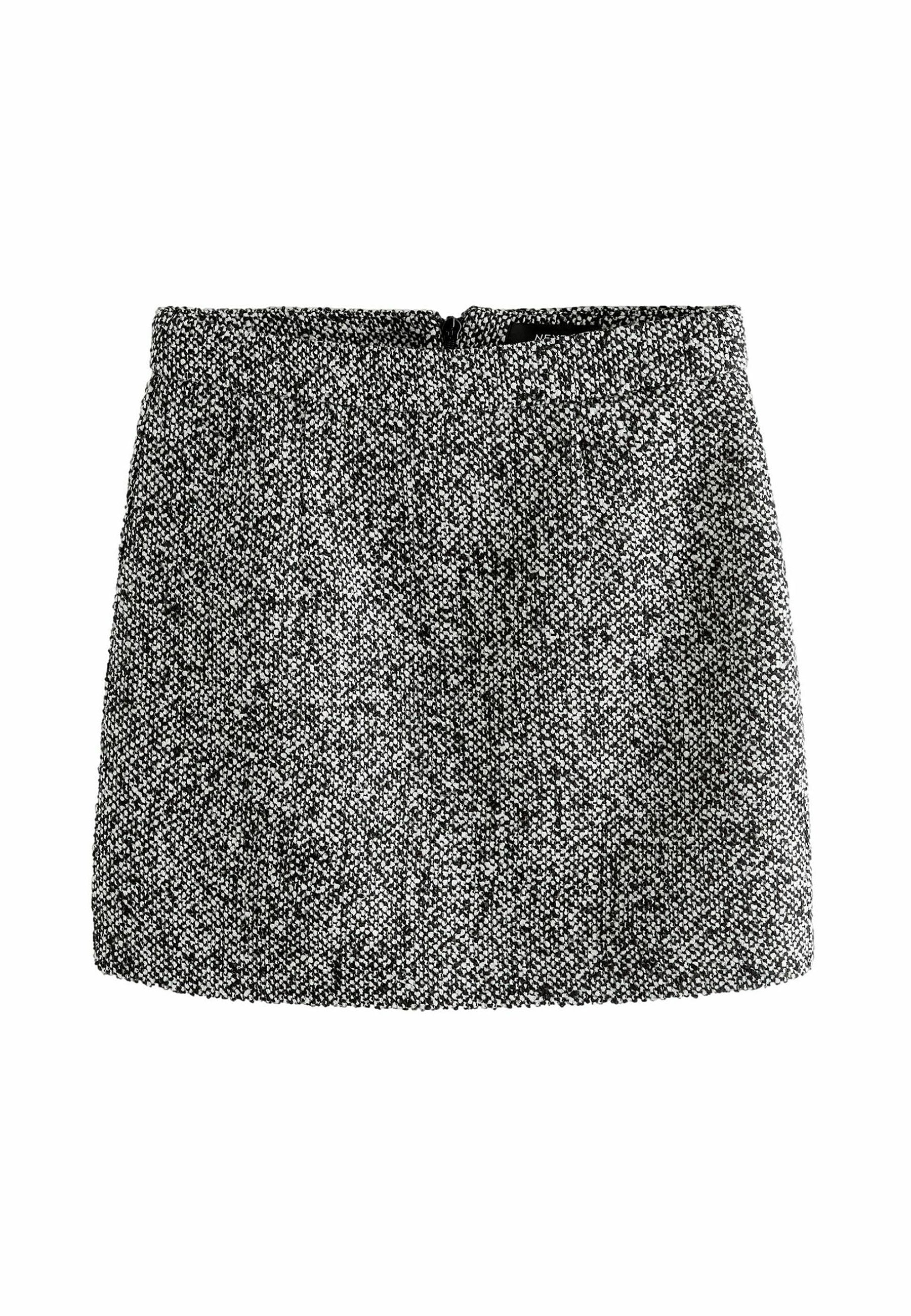 Schwarzer und weißer strukturierter Rock mit hoher Taille, geradem Schnitt und kurzer Länge; verfügt über einen Reißverschluss auf der Rückseite.