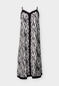Ärmelloses, schwarz-weiß gestreiftes Slip-Kleid im Zebra-Look mit dünnen Trägern, schwarzer Einfassung entlang des Ausschnitts, der Mitte und des Saums.