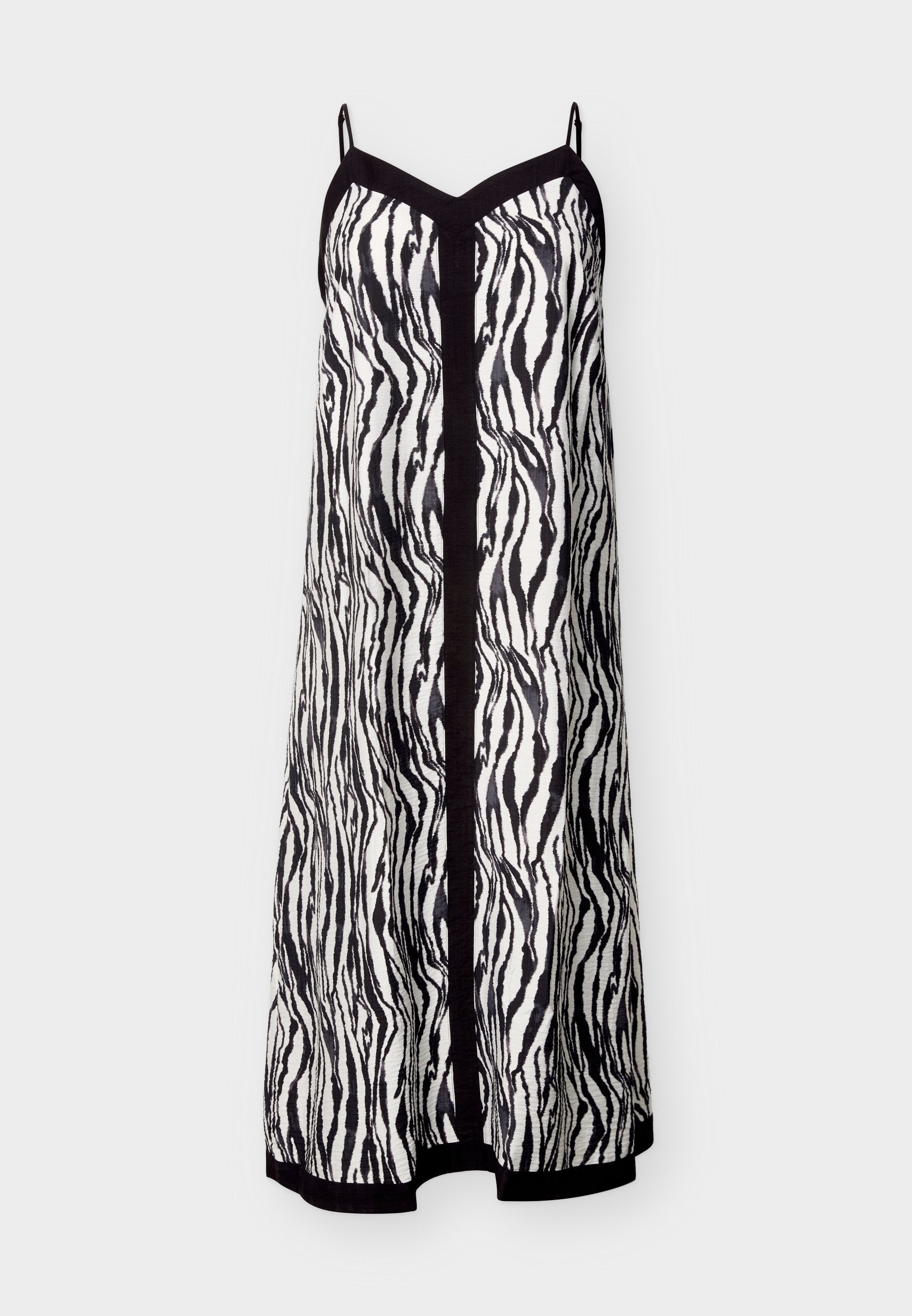 Ärmelloses, schwarz-weiß gestreiftes Slip-Kleid im Zebra-Look mit dünnen Trägern, schwarzer Einfassung entlang des Ausschnitts, der Mitte und des Saums.